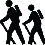 Black and white clip art of two people hiking with sticks.